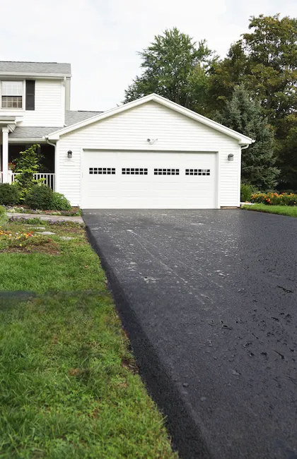 Front view of a driveway asphalt surface protected with high-quality driveway sealcoating.